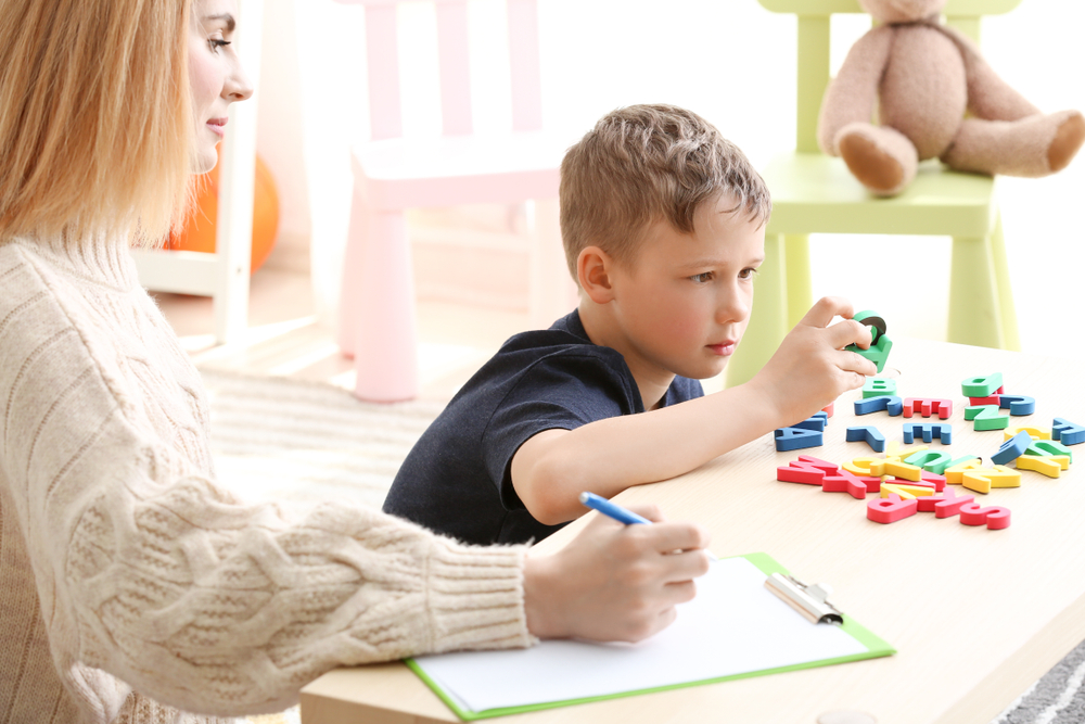 Female,Psychologist,Working,With,Boy,Suffering,From,Autistic,Disorder Autism Testing